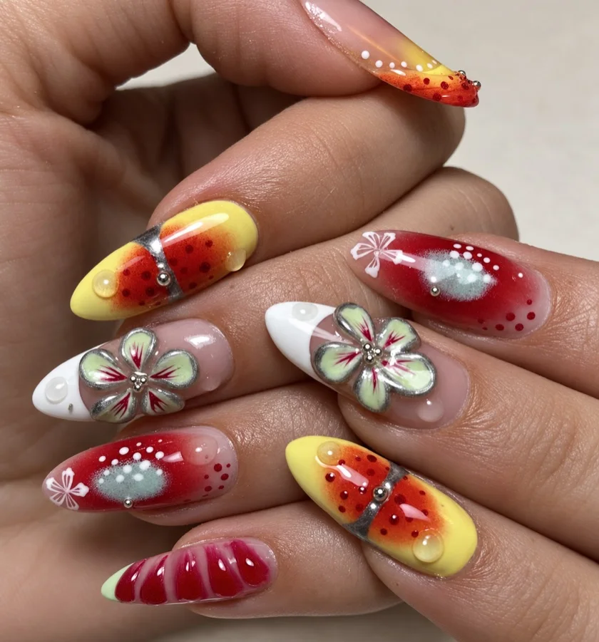 Lange nagels met bloemen in reliëf, vlinders en rode en gele kleurverlopen